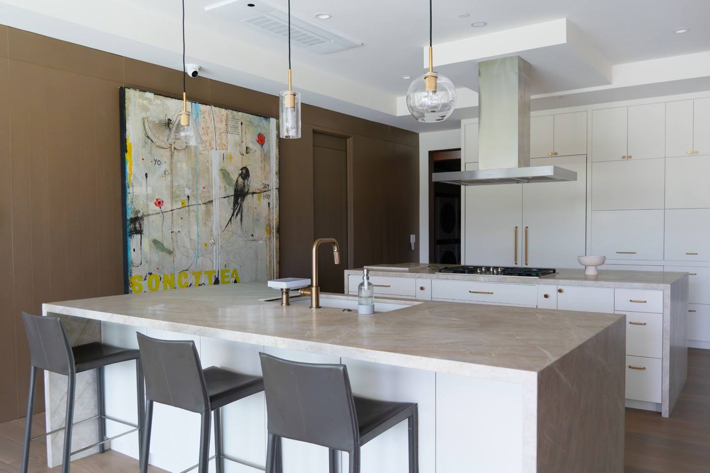Kitchen with island seating and integrated appliances