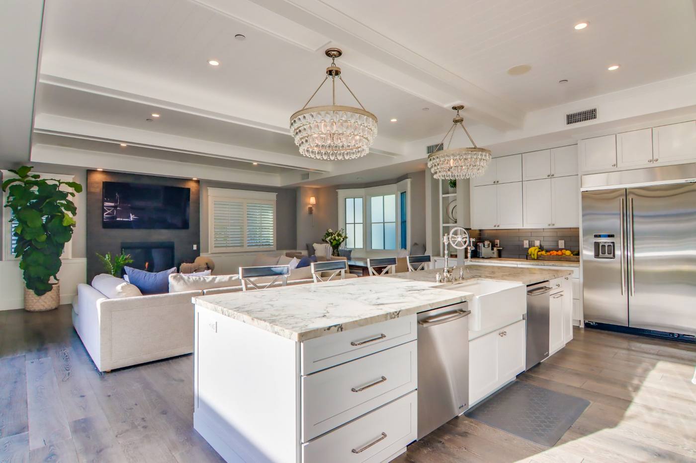 Chef's kitchen with marble island and crystal chandeliers