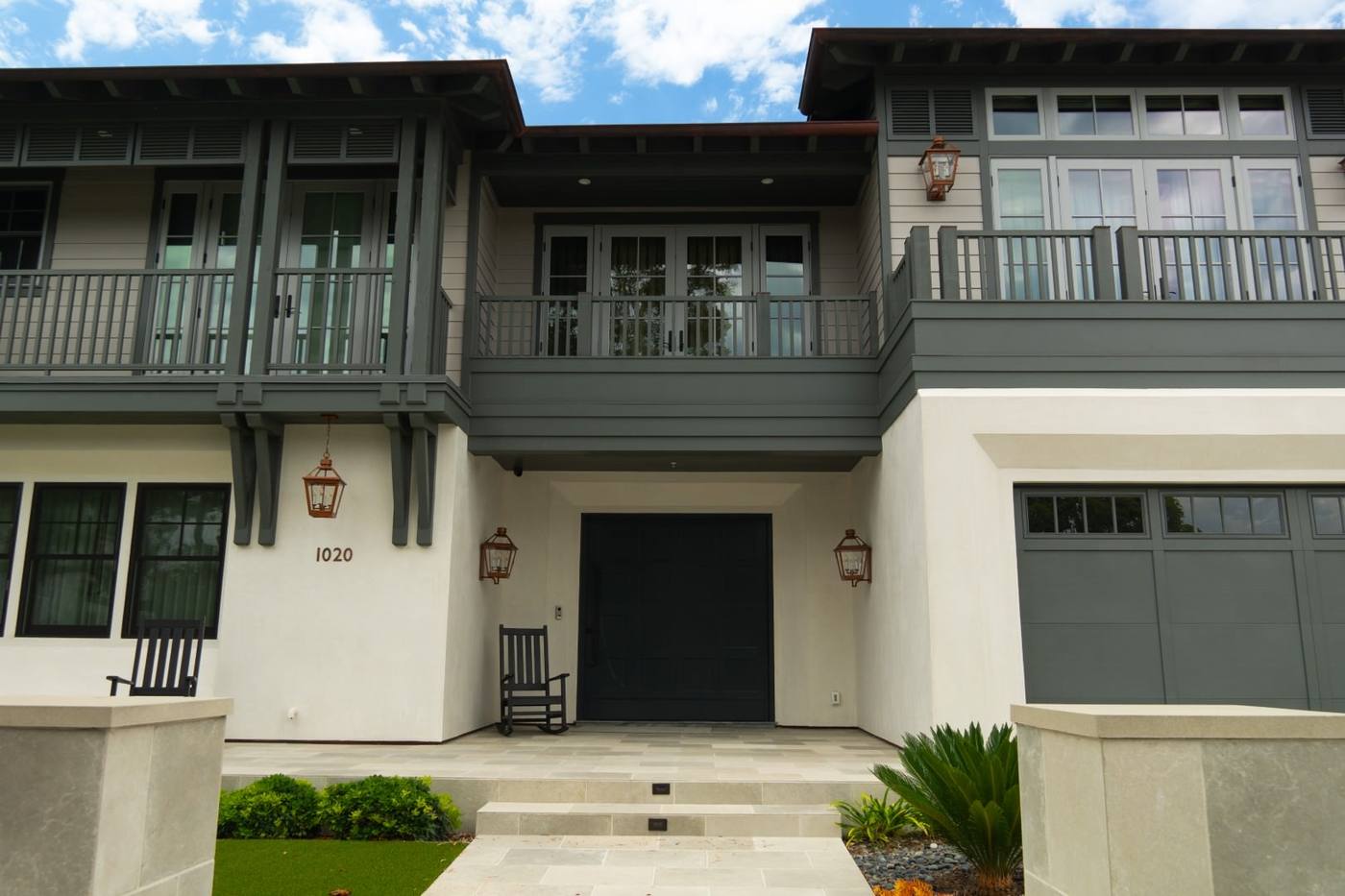 Front elevation with dual covered balconies and board and batten siding