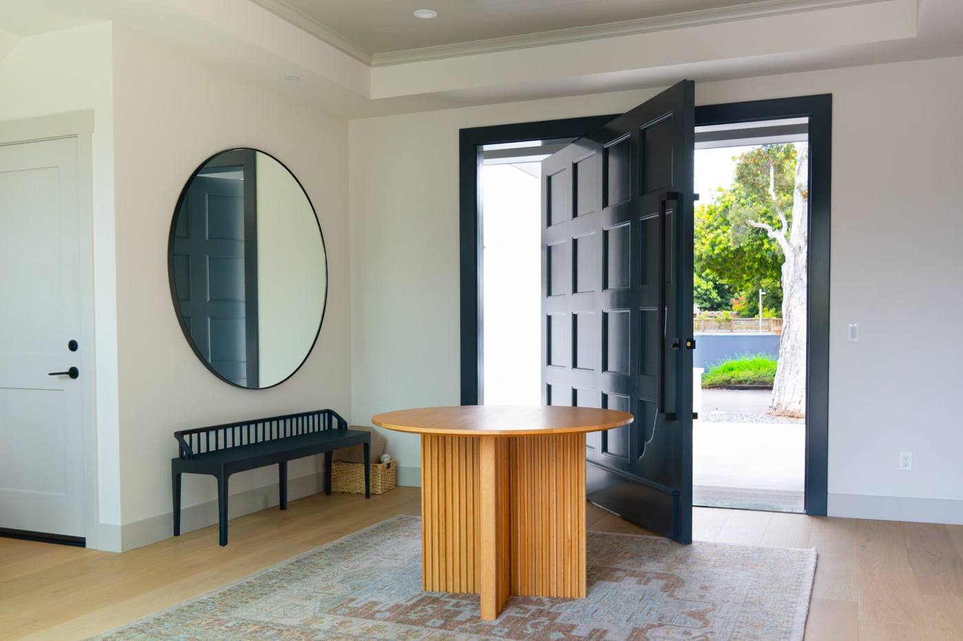 Entry with dark front door open to the street