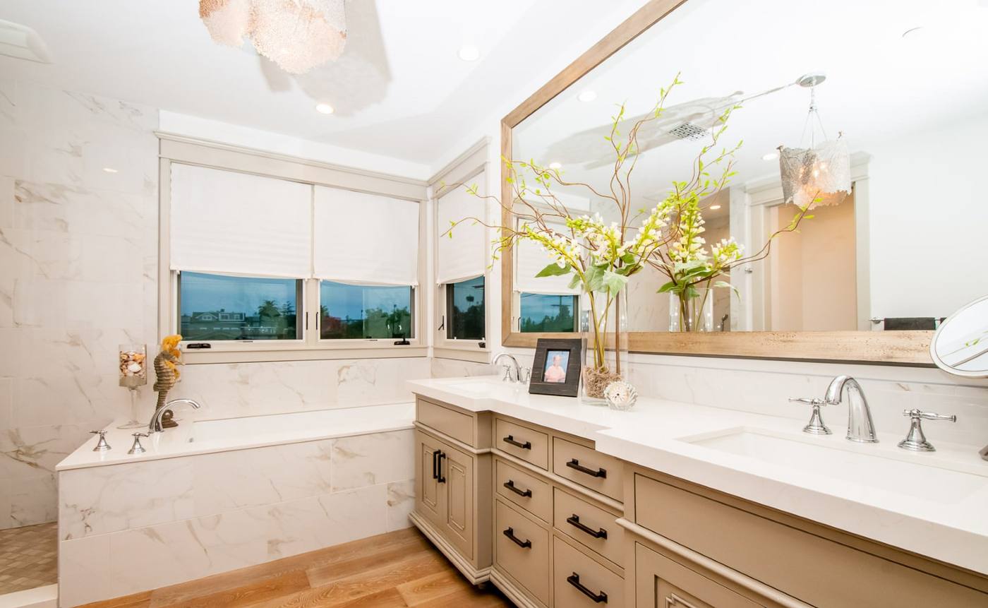 Primary bathroom with soaking tub and marble surfaces