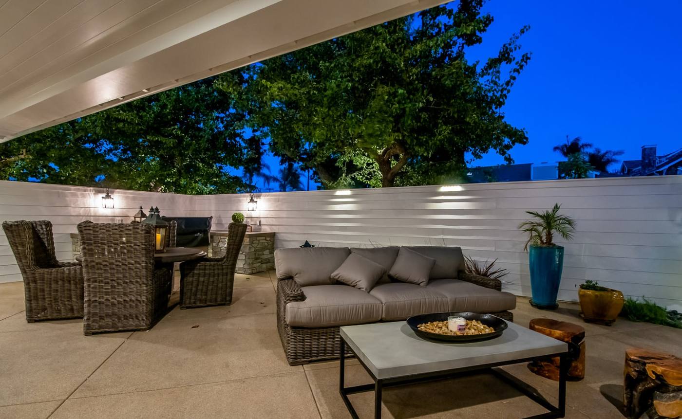 Covered outdoor living area lit at dusk