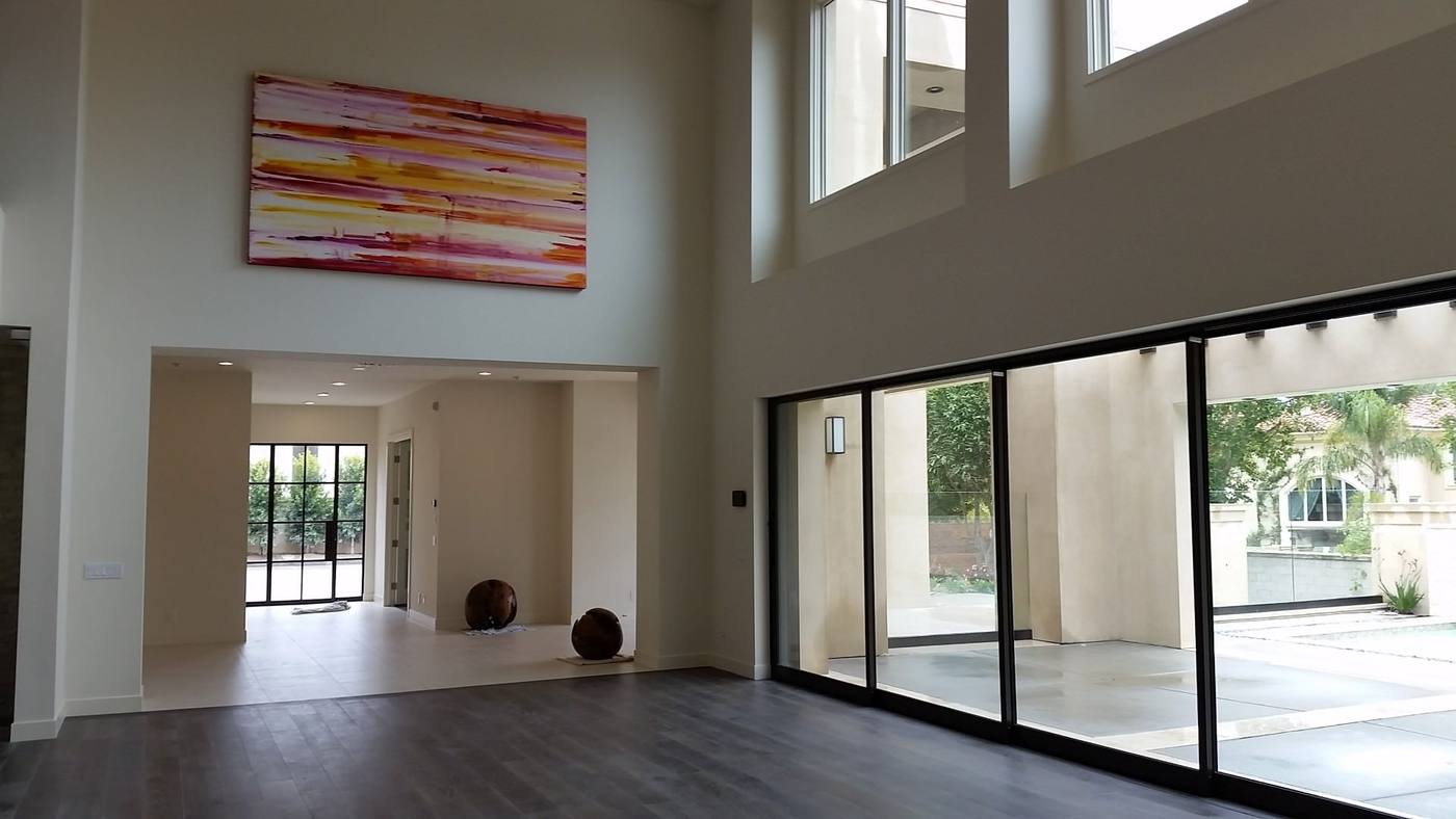 Double height living volume with tall glazing