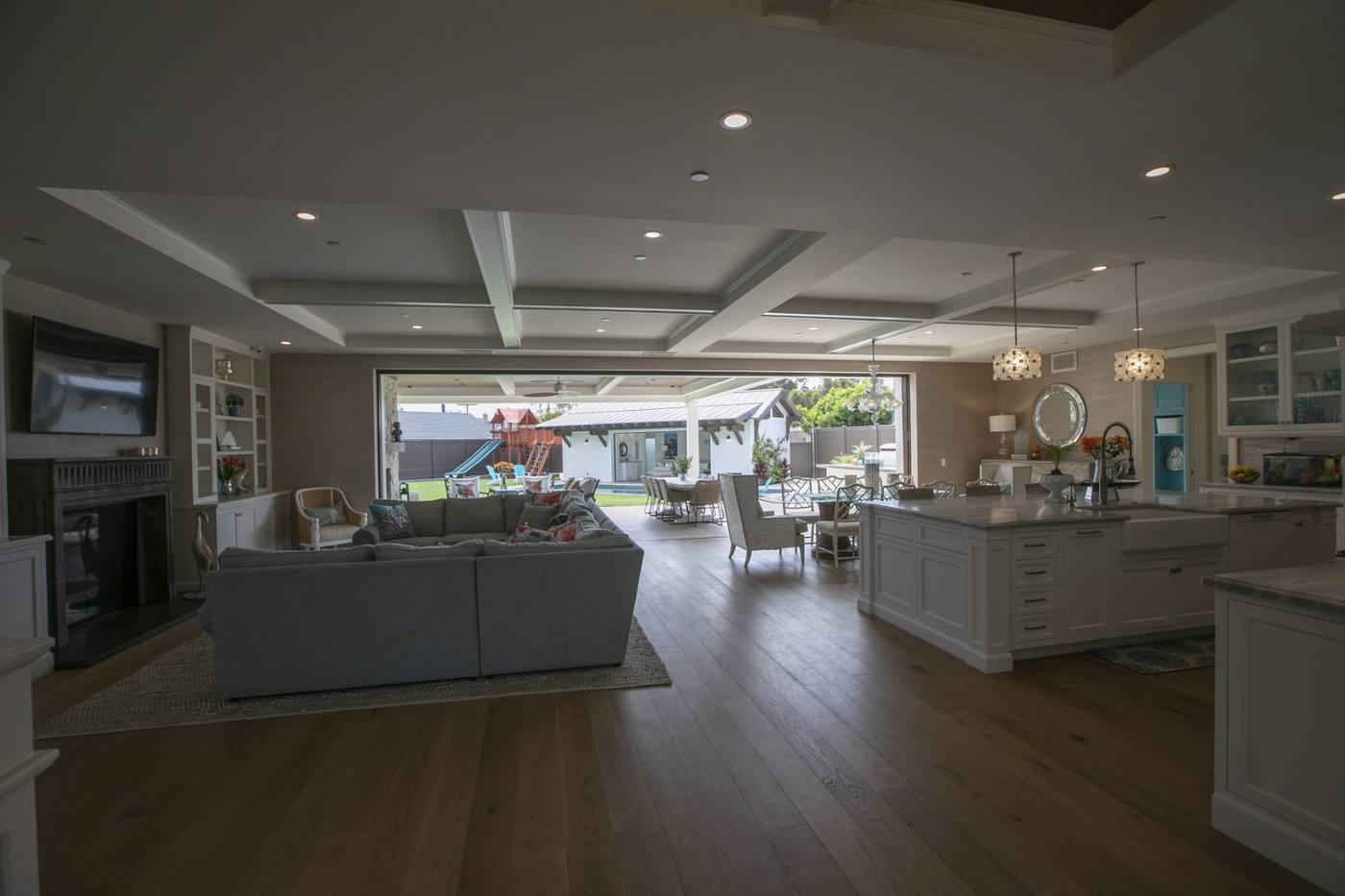 Great room with coffered ceiling open to the rear yard