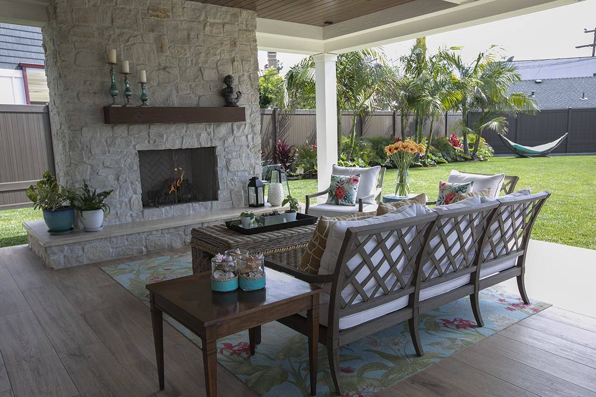 Covered outdoor living area with stone fireplace