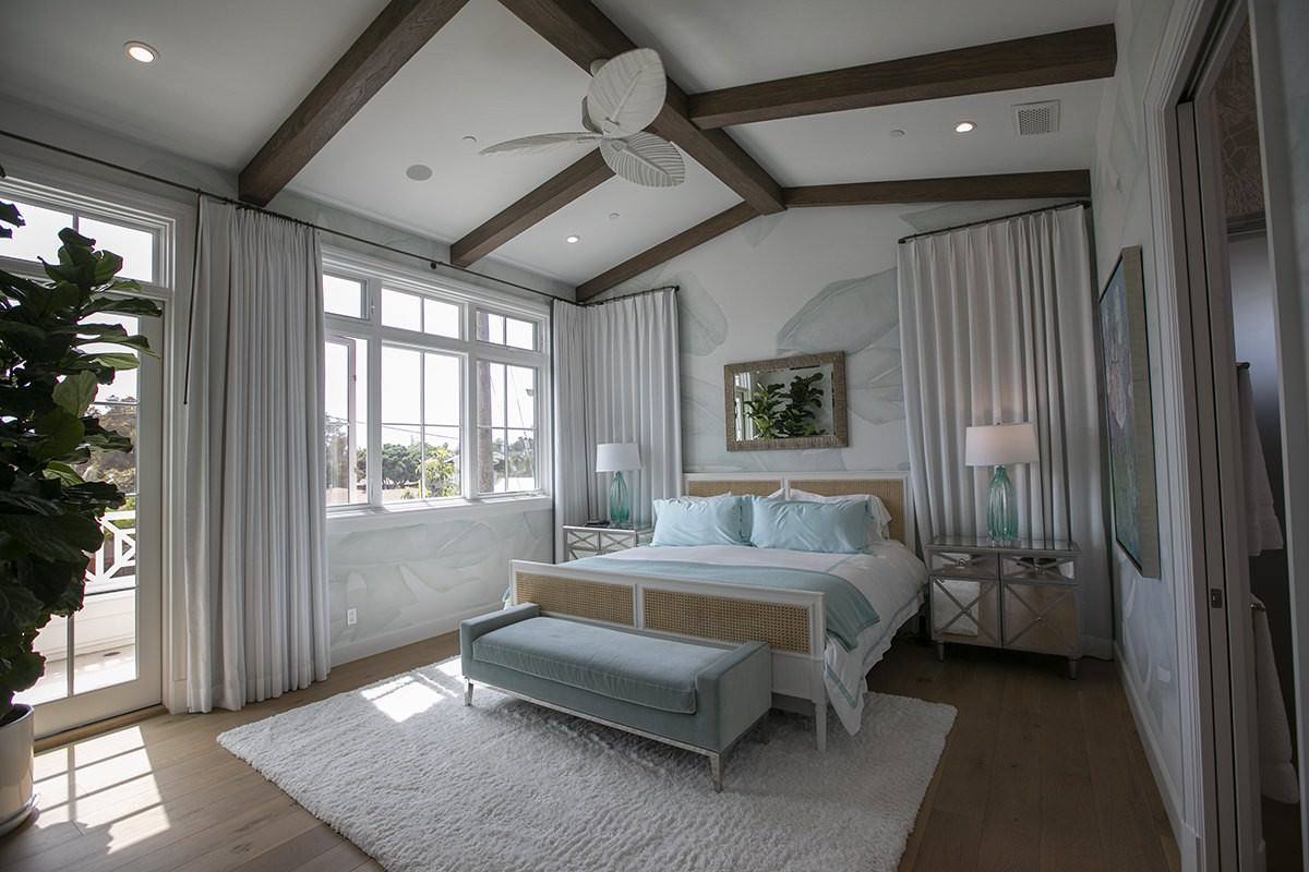 Primary bedroom with vaulted ceiling and exposed beams