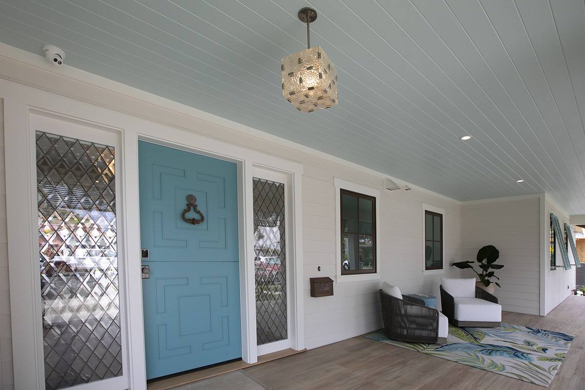 Entry hall with painted door and vaulted plank ceiling