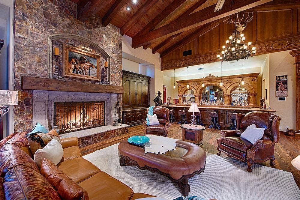 Great room with stone fireplace and timber ceiling