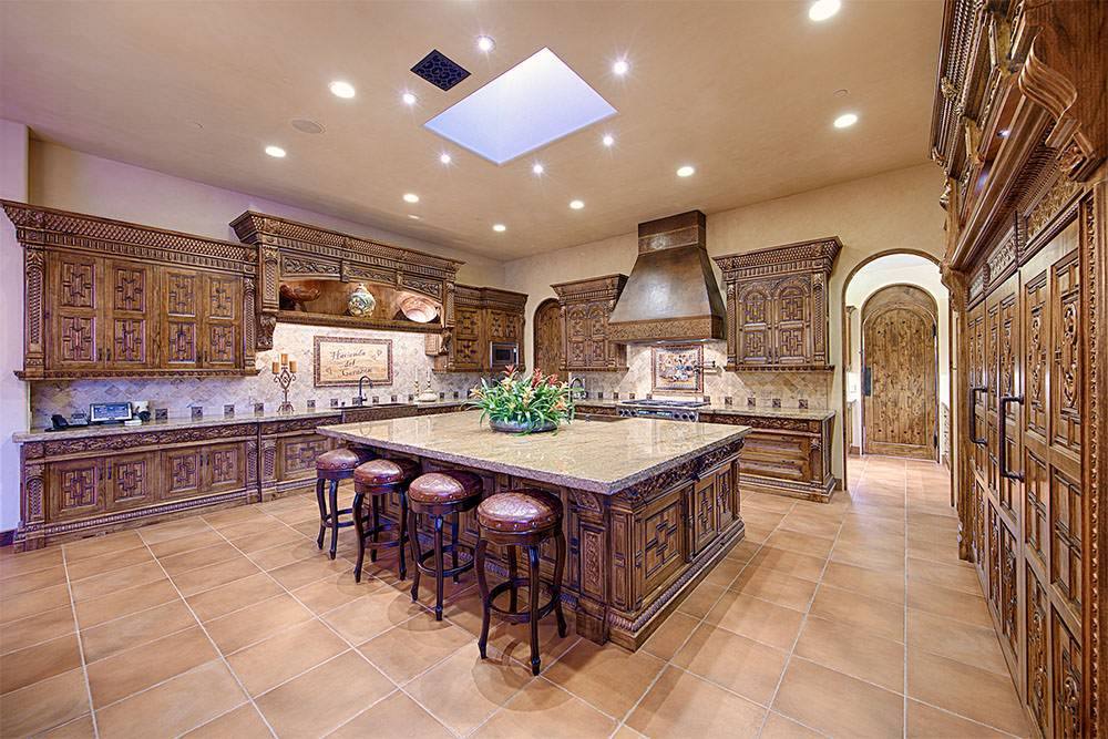 Kitchen with carved range hood and island seating