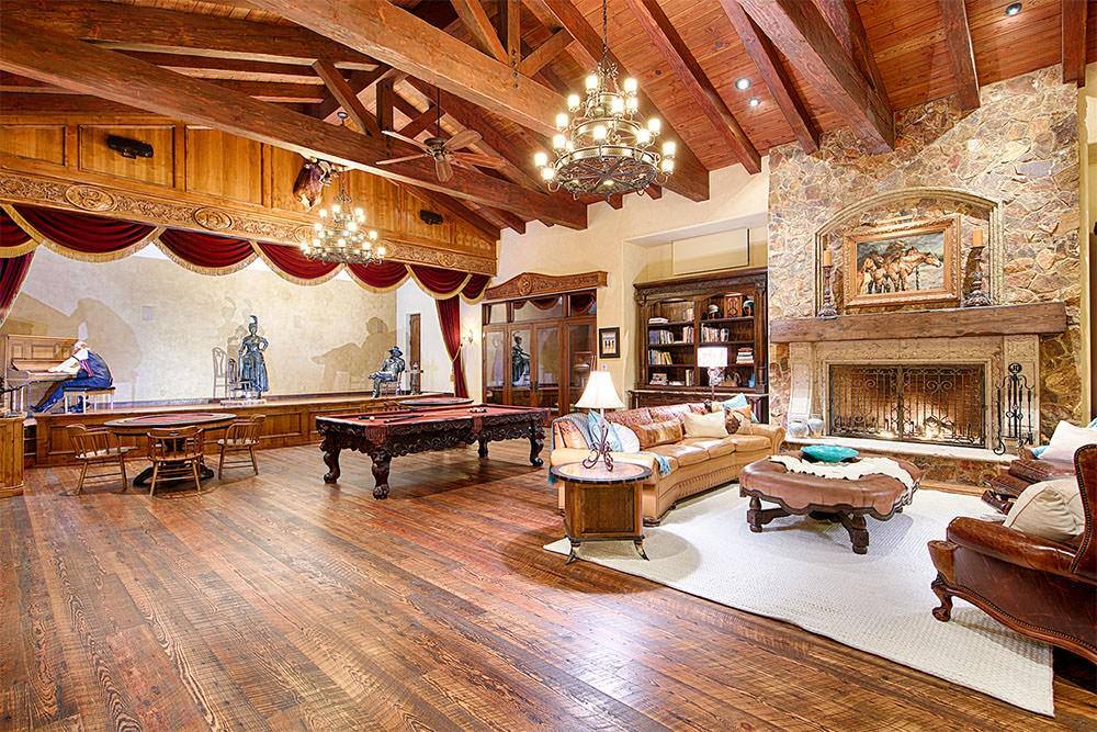Game room with billiards table and timber trusses